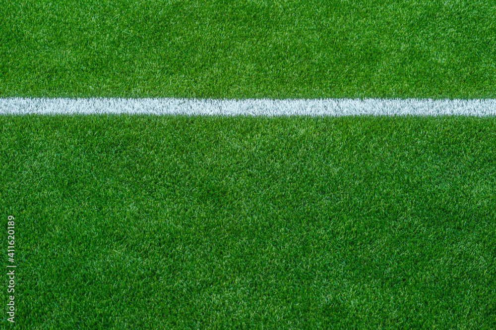 Green synthetic grass sports field with white line shot from above. Soccer, rugby, football, baseball sport concept Green synthetic grass sports field with white line shot from above. Soccer, rugby, football, baseball sport concept
