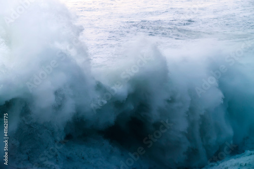 giant waves breaking on a stormy day in atlantic sea ocean