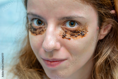 Beautiful model using coffee with coconut oil for dark circles under her eyes