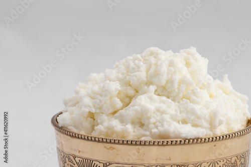 Detailed Closeup Of Freshly Churned White Butter Also Known As Safed Makhan Malai Or Homemade Makkhan In India Is Enjoyed With Breads Parathas Rotis And Sandwiches. White Background With Copy Space photo