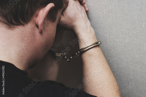 Canvas Print Man in handcuffs is praying for forgiveness