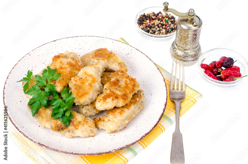 Breaded chicken fillet pieces on plate