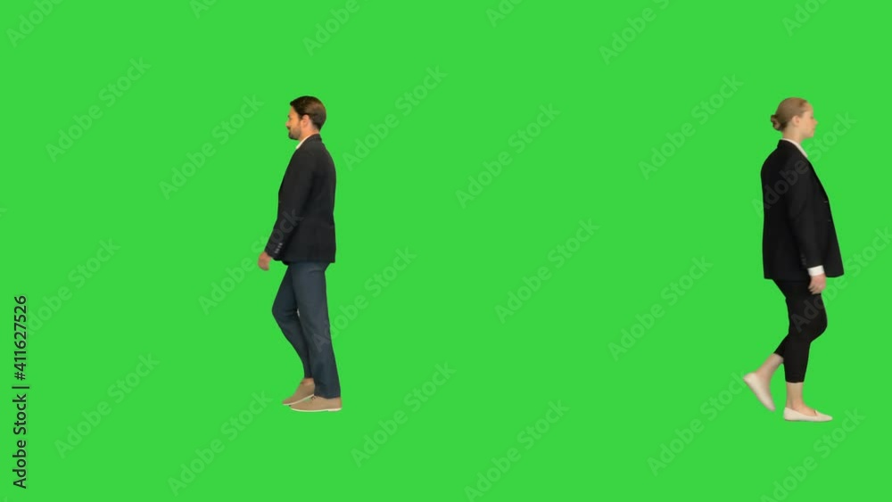 Confident business partners walking passing by each other on a Green Screen, Chroma Key. Confident business partners walking passing by each other on a Green Screen, Chroma Key.