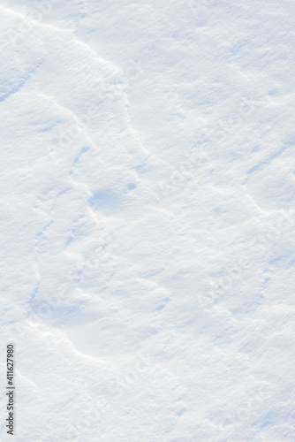 Fresh clean white snow background texture. Winter background with snowflakes and snow mounds. Snow lumps. Seasonal landscape details. © Сyrustr