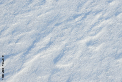 Fresh clean white snow background texture. Winter background with snowflakes and snow mounds. Snow lumps. Seasonal landscape details.