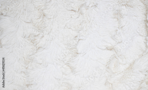 Soft white fur background. Light artificial fur textile material.