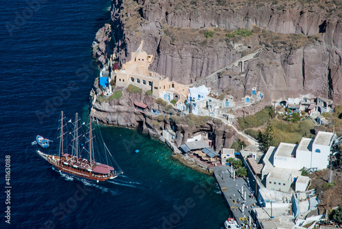 Santorini - view of a rocky gulf and old boats in a harbour