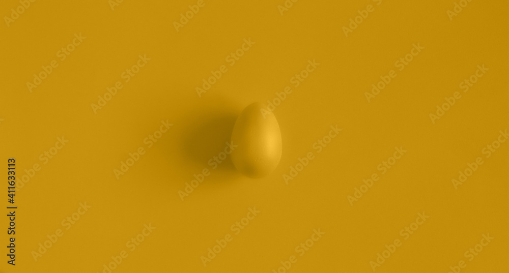 Yellow Easter egg on a yellow background. Background for design. Easter background. Easter. Copy space. Yellow Easter egg on a yellow background. Background for design. Easter background. Easter. Copy space.