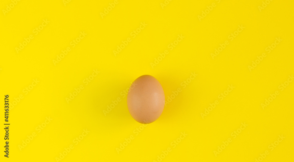 Egg on a yellow background. Background for design. Easter background. Easter.Copy space. Egg on a yellow background. Background for design. Easter background. Easter.Copy space.