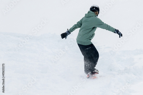 Woman riding a snowdeck snowskate snowboard
