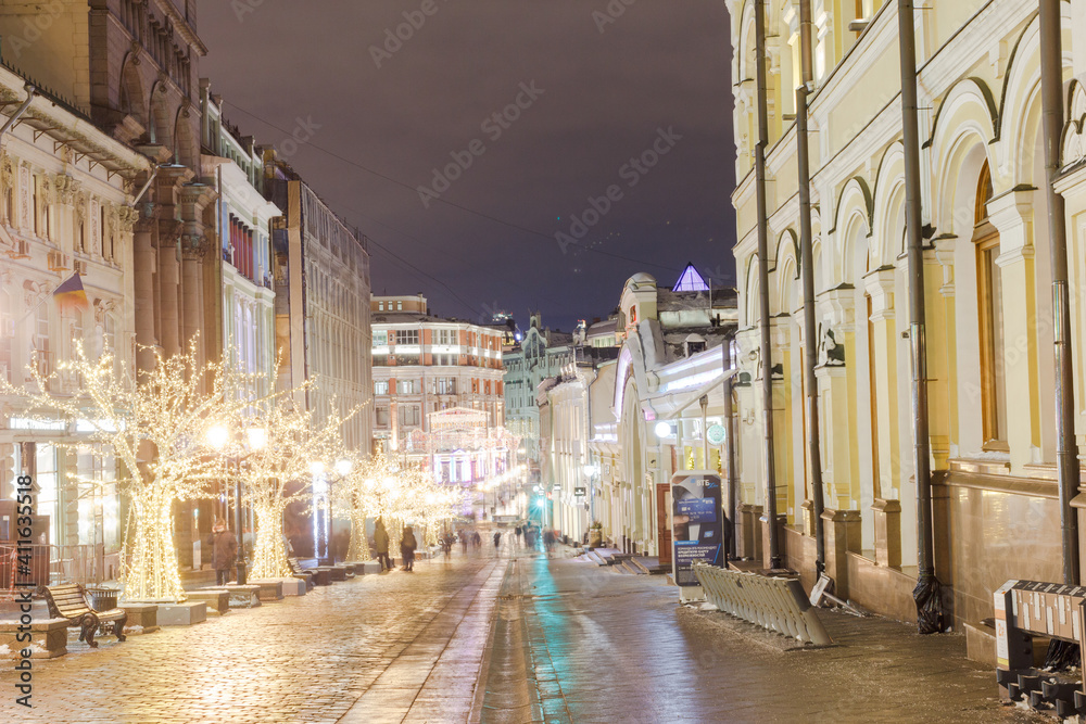 Moscow, Russia, Jan 20, 2021: Pedestrian zone at Kuznetsky most street. New year decorations. Festive illumination. Shot in long exposure.