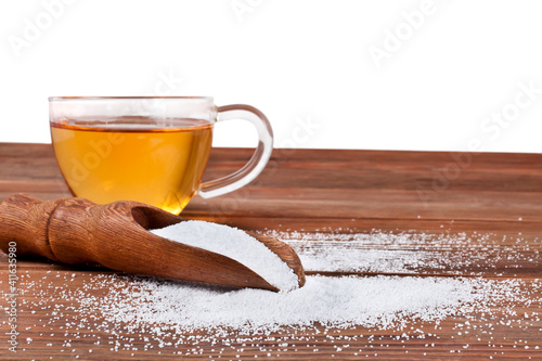 Cup of tea and scoop of sorbitol isolated on a white background. Sweeteners and diet concept. photo