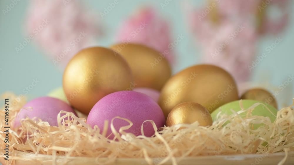 Easter eggs in straw spin on blue background Easter eggs in straw spin on blue background