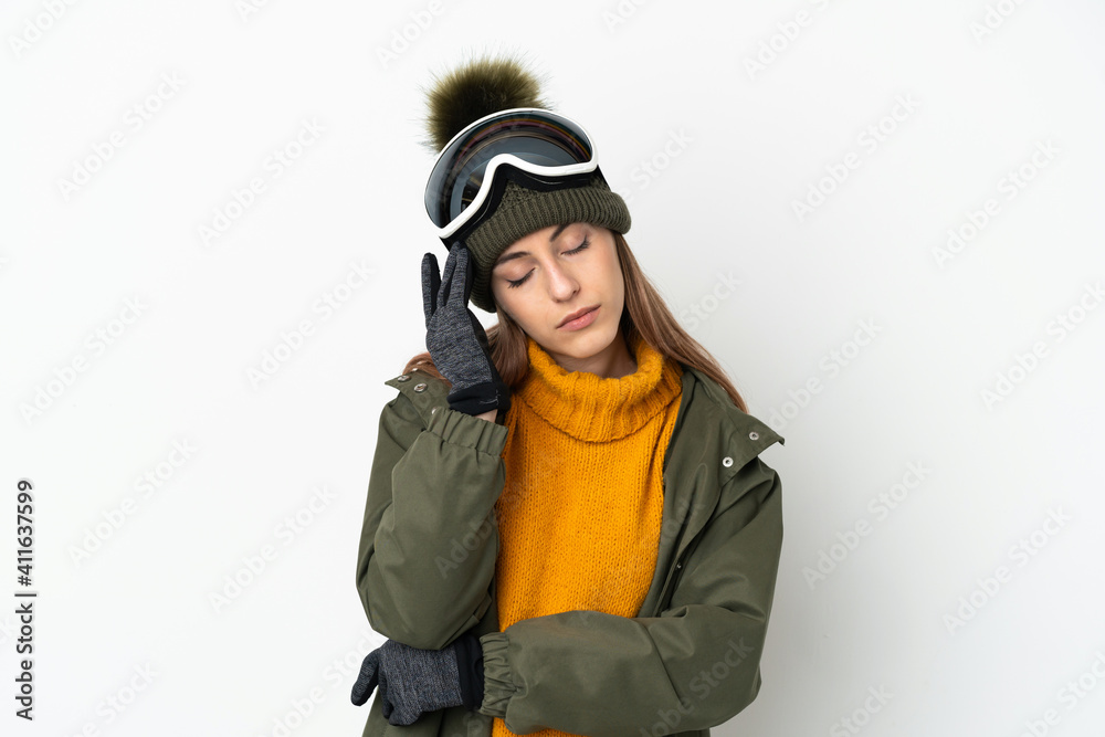 Skier caucasian woman with snowboarding glasses isolated on white background with headache Skier caucasian woman with snowboarding glasses isolated on white background with headache