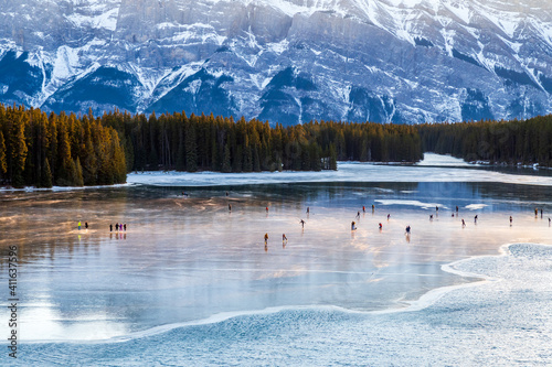 Canvas Print Beautiful view of people ice-skating on the Two Jack Lake in Banff national park