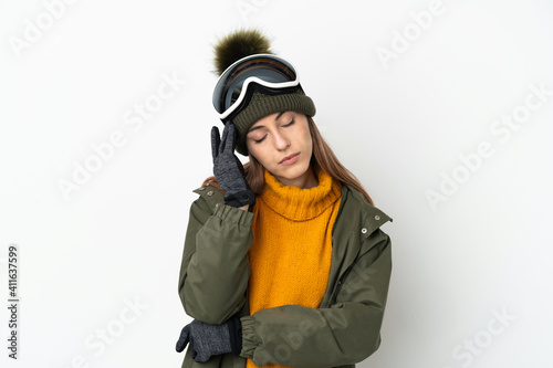 Skier caucasian woman with snowboarding glasses isolated on white background with headache
