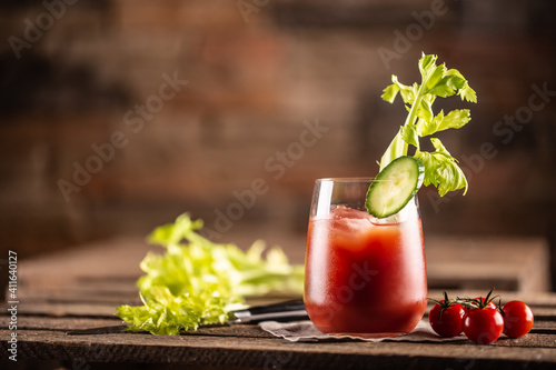 Classic bloody mary or virgin mary vodka cocktail in a cup with as a hangover drink in a rustic envrionment © weyo
