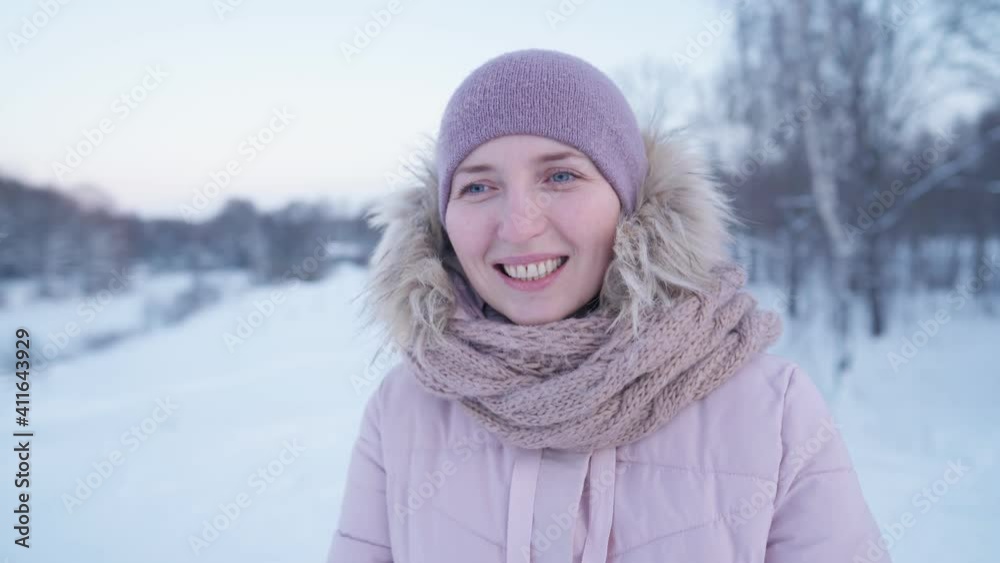 Portrait of a woman frozen in winter in the park, riding with children from a snow slide on a tubing. Winter vacation. Frosty winter. Portrait of a woman frozen in winter in the park, riding with children from a snow slide on a tubing. Winter vacation. Frosty winter.