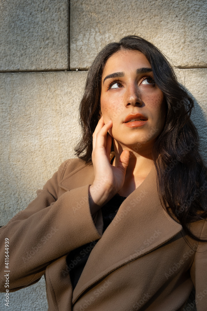 portrait of a brunette woman wearing a coat 
