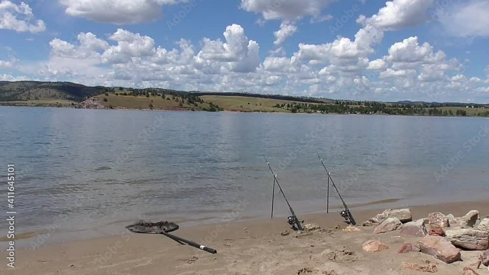 Calm Water Lake, Beach, Fishing Rods, Net, Blue Sky, Clouds, Scenic Calm Water Lake, Beach, Fishing Rods, Net, Blue Sky, Clouds, Scenic