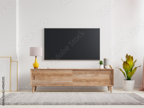 Mockup a TV wall mounted in a living room room with a white wall.