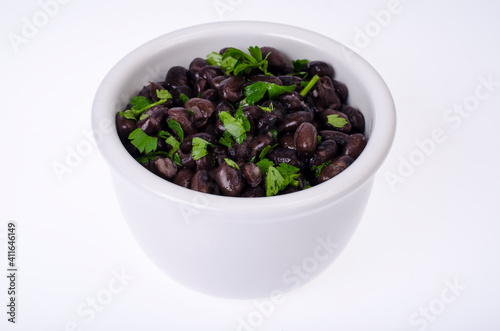 Dark red canned beans in white bowl