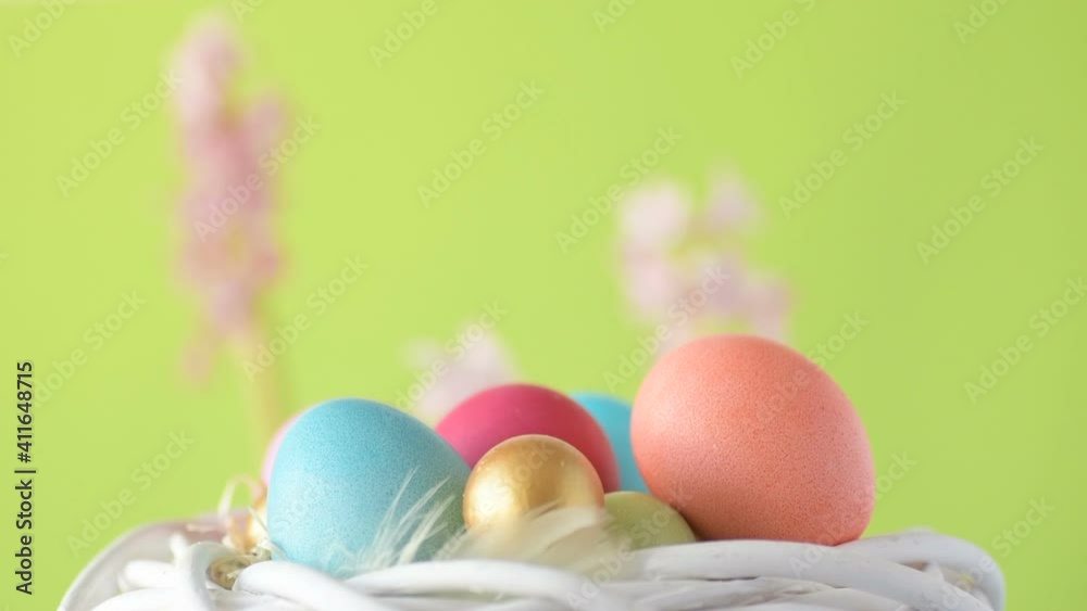 Easter eggs in straw spin on green background Easter eggs in straw spin on green background