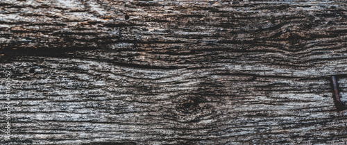 Grunge wood material surface, old hardwood planks, atmospheric exposure, outdoors. Dark texture close-up.