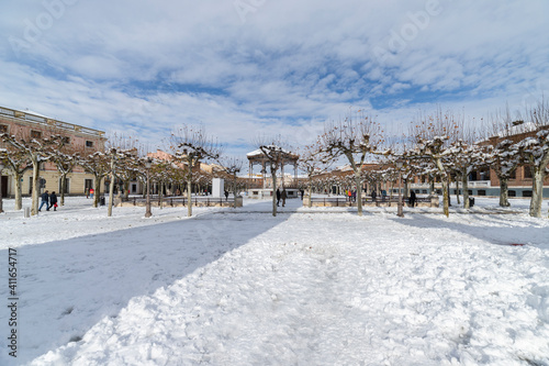 Cervantes square in the city of alcala de henares covered in snow