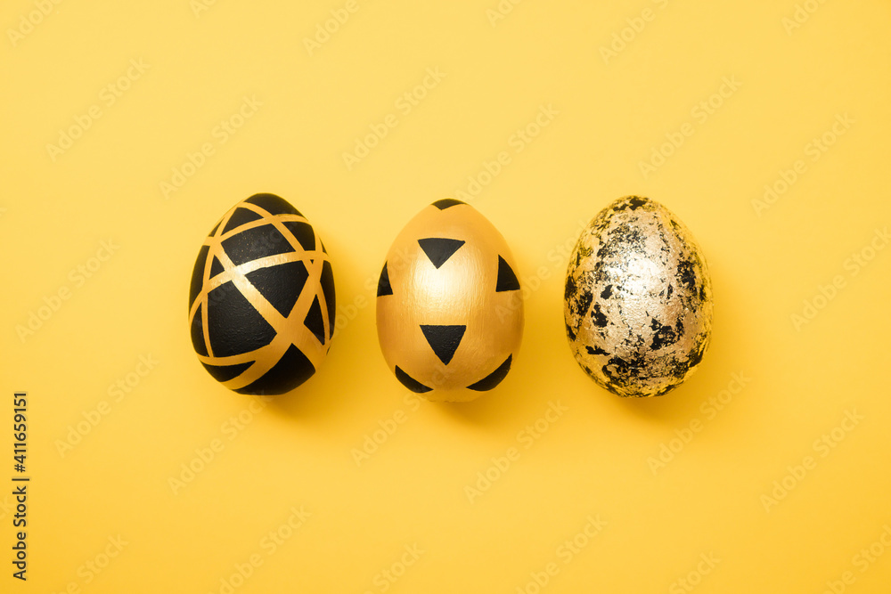 Easter golden decorated eggs on yellow background. Minimal easter concept. Happy Easter card with copy space for text. Top view, flatlay - obrazy, fototapety, plakaty 