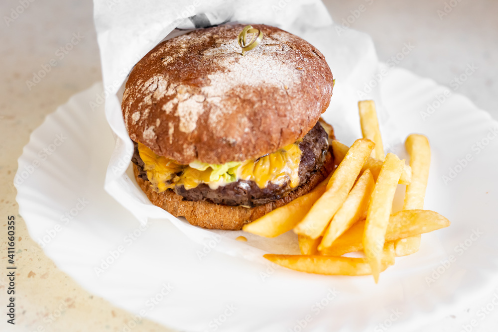 Cheeseburger with french fries on white plate. Isolated on white top view. Cheeseburger with french fries on white plate. Isolated on white top view.