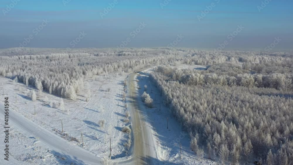 Aerial video of winter road surrounded by birch forest. Aerial video of winter road surrounded by birch forest.