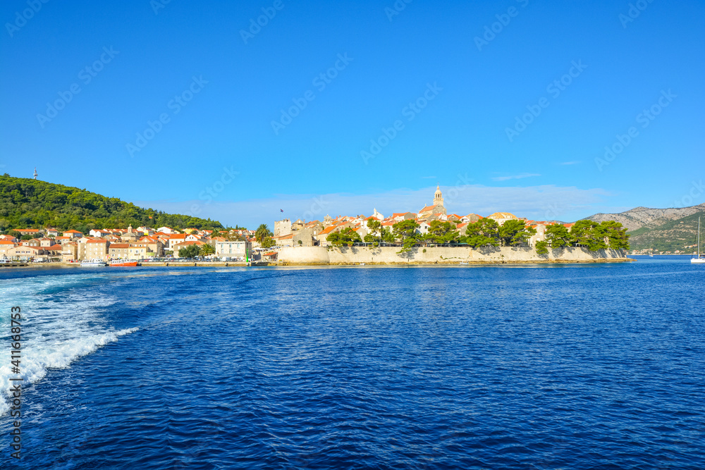 View from the Adriatic sea of the island of Korcula, Croatia, on the Dalmatian Coast on a sunny summer day.