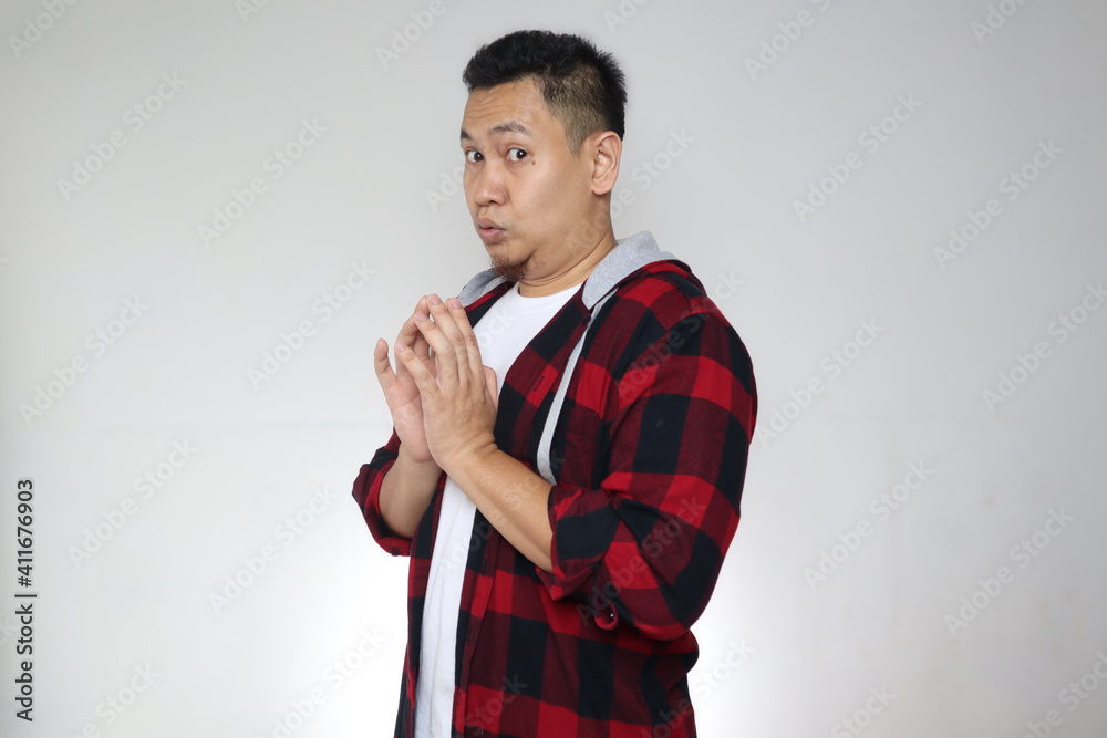 Asian man looking to camera with embarrased worried hoping something gesture, shocked expression Asian man looking to camera with embarrased worried hoping something gesture, shocked expression