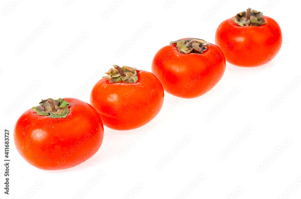 Heap of ripe sweet orange persimmons isolated on white background. Studio Photo Heap of ripe sweet orange persimmons isolated on white background. Studio Photo