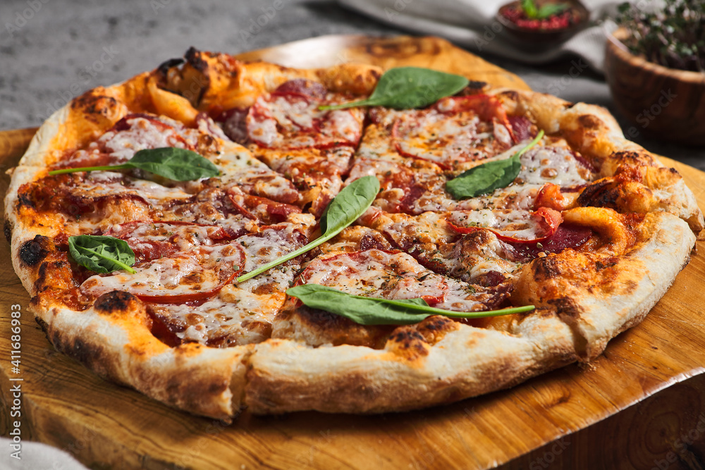 Pepperoni Pizza on Wooden Trat with Textile Napkin Pepperoni Pizza on Wooden Trat with Textile Napkin