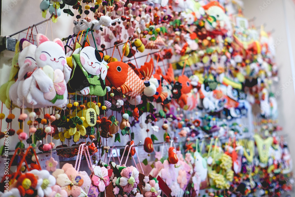 Traditional craft cotton toy with form of cats, fish, sakura flowers and others at store in Nishiki Market, Kyoto, Japan