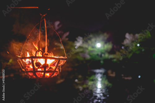 Old fire lamp hanging in a lagoon in Yasaka shrine in night  Kyoto  Japan