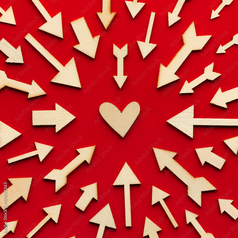 Dozens of arrows pointing at a single heart. Romantic concept with arrows as signals for romance. Dozens of arrows pointing at a single heart. Romantic concept with arrows as signals for romance.