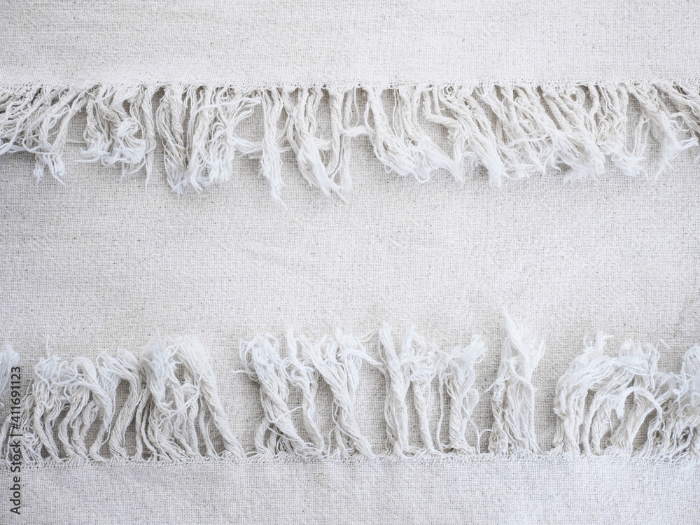 Ταπετσαρία Close up beige cotton fabric texture with fringe edge.
