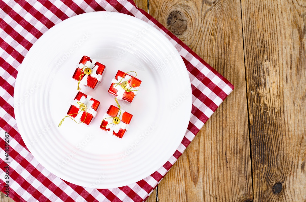 Christmas and New Years concept. White plate, red tablecloth. Studio Photo Christmas and New Years concept. White plate, red tablecloth. Studio Photo