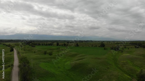 Beautiful green hills. White clouds. Mountain panorama. Aerial video. In the spring. Beautiful advertising of nature.