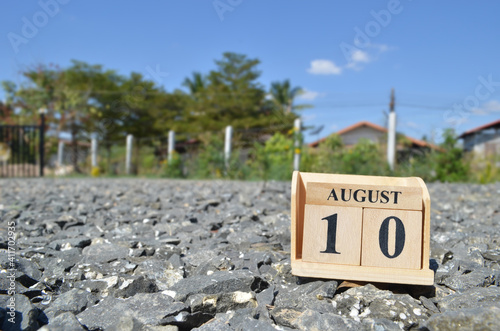 August 10, Number cube with a natural background.