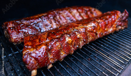 Obraz na płótnie Babyback pork ribs cooking on a pellet grill smoker w salonie