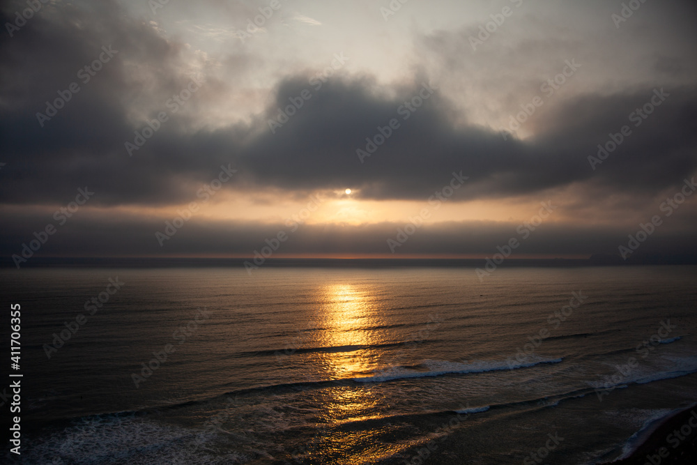 Naklejka premium Pacific Ocean in Lima, Peru. Sunset in Peru. Green Coast.