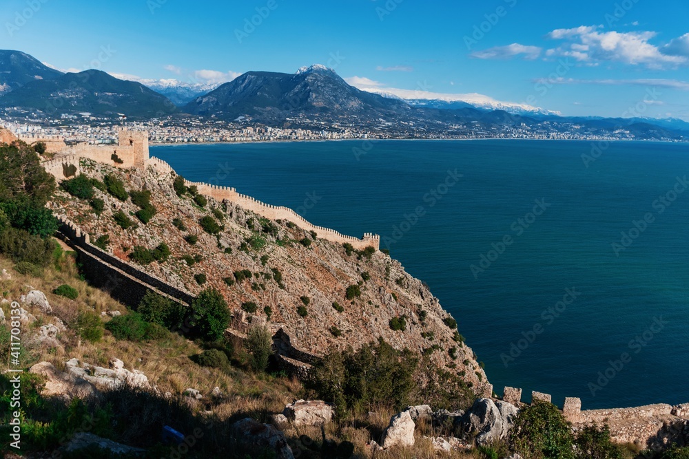 Top view of the wall, a fortress in Alanya over the sea. Beautiful landscape of mountains, sea, city and local attractions in Turkey.