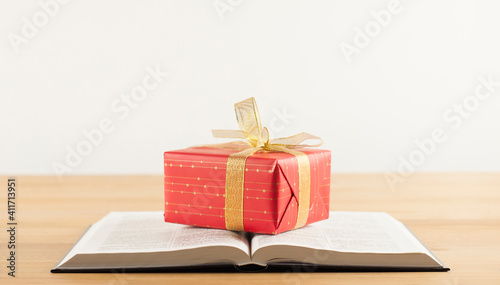 Fotografie, Obraz Open Bible book on a wooden table