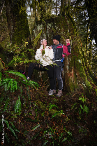 Young couple having fun in forest. Lynn Headwaters park in North Vancouver. British Columbia. Canada 