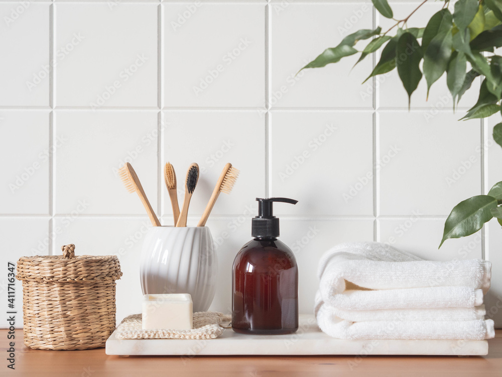White bath background front view with cosmetic bottle and bath accessories White bath background front view with cosmetic bottle and bath accessories