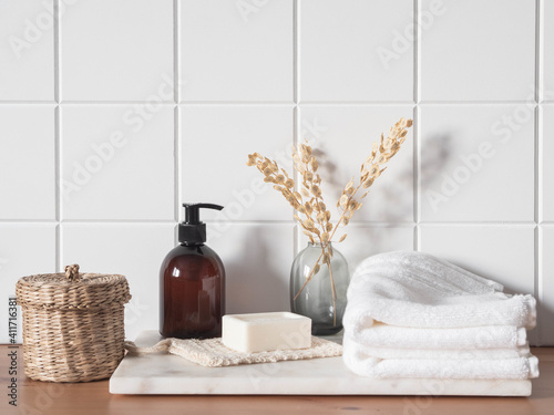 White bath background front view with cosmetic bottle and bath accessories